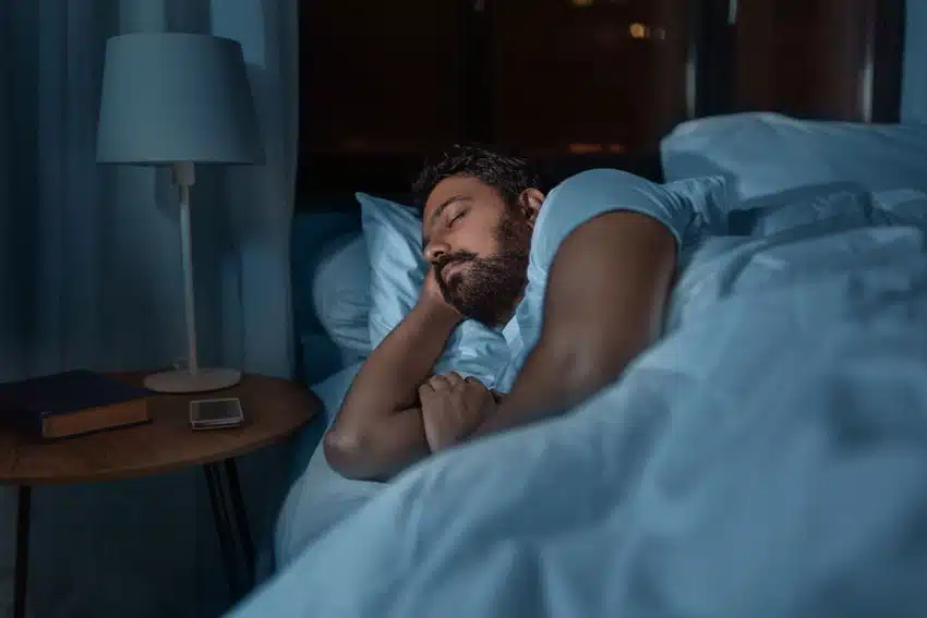 adult man sleeping in bed