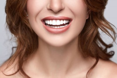 Closeup of a woman's bright, healthy smile