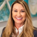 JaniceD-min (1) Women with long hair smiling showing teeth